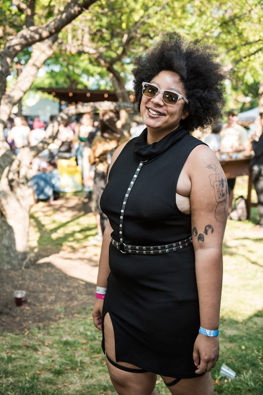 A woman in a short black dress and leather harness at the Pitchfork Music Festival