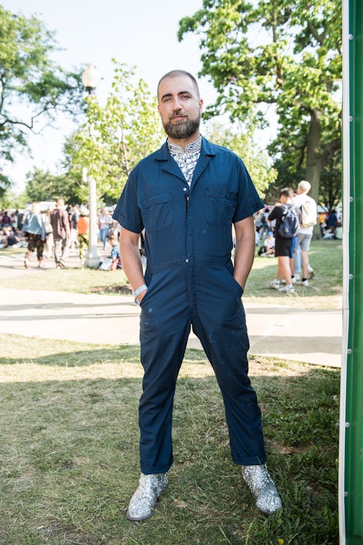 A man in a blue jumpsuit and a white T-shirt attending the Pitchfork Music Festival