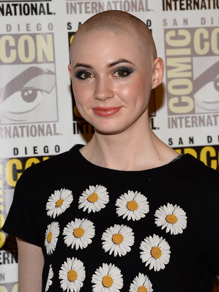 Karen Gillian with a buzz haircut in a black top with dandelion print at the San Diego Comic Con