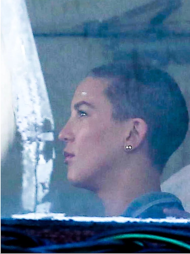 A side-profile shot of Kate Hudson in a car with shaved hair