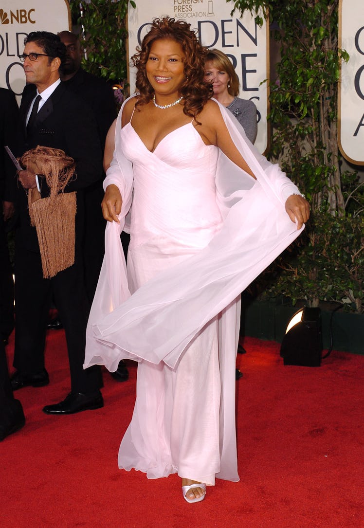 Queen Latifah posing in a white long dress at the 61st Annual Golden Globe Awards red carpet