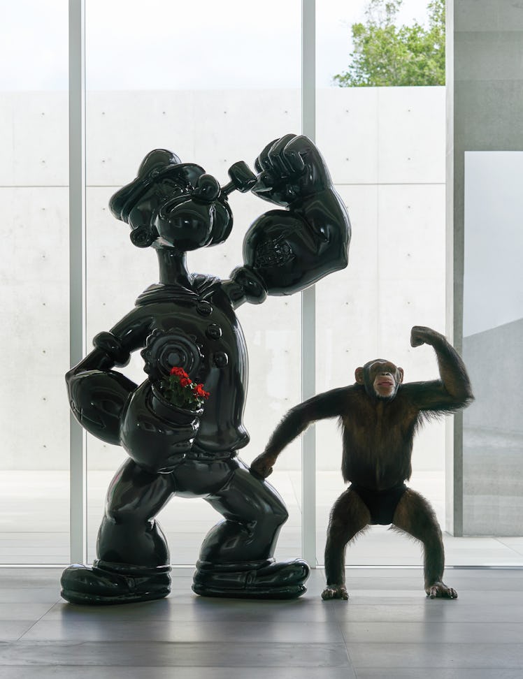 Chimpanzee Eli with one arm raised next to Jeff Koon's Popeye by Alex Israel