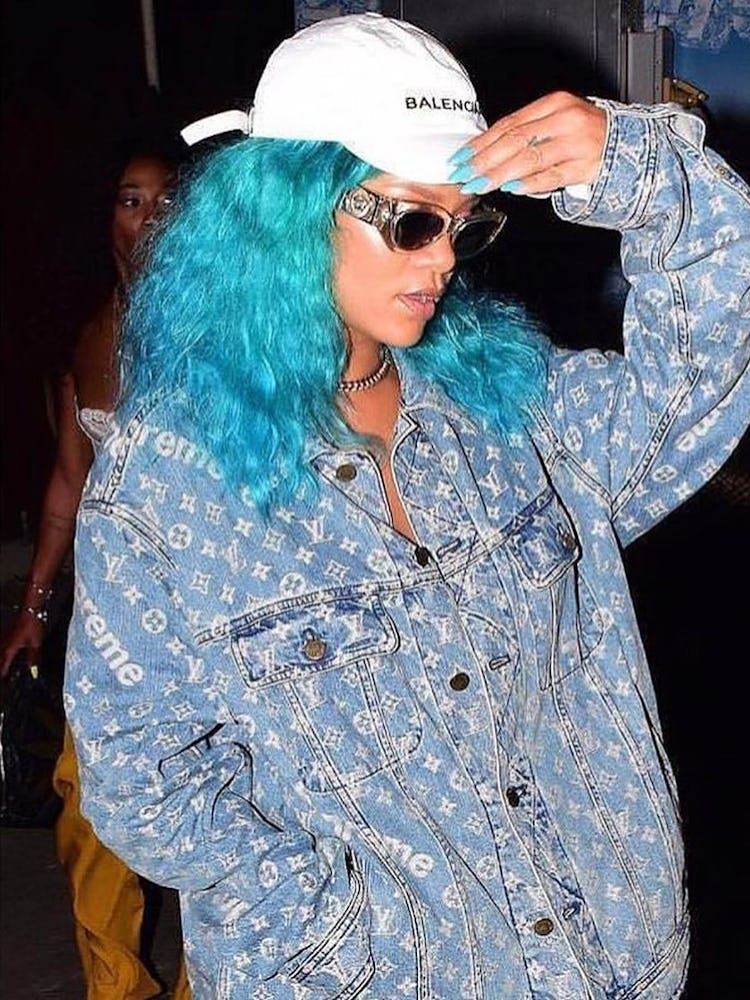 Rihanna with her hair in long turquoise beach waves and matching nails at a festival in Barbados 