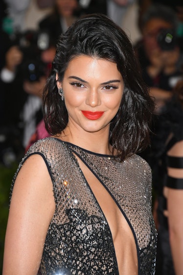 Kendall Jenner rocks a stunning coral lip that perfectly complements her sleek, wet waves.