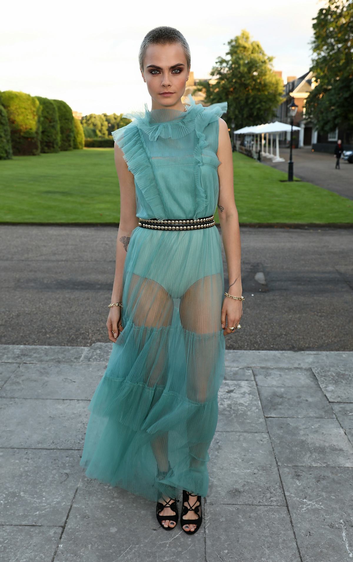 Cara Delevingne on a lawn.