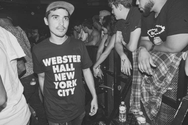 A young man wearing a black shirt with "WEBSTER HALL NEW YORK CITY" text