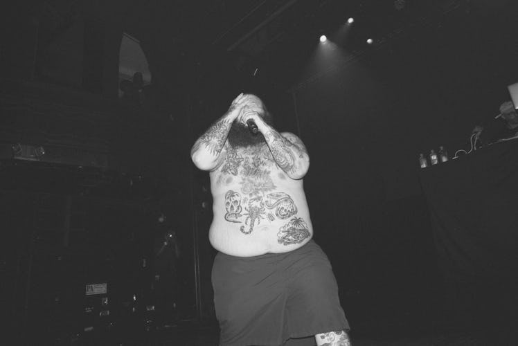 Action Bronson singing during his concert while being without a shirt