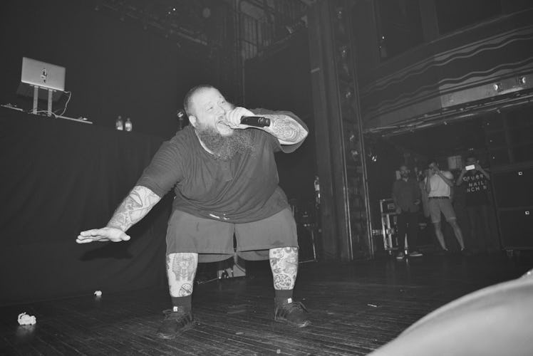 Action Bronson holding a microphone during his concert