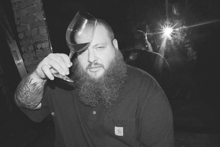 Action Bronson holding a glass of his beloved natural wine