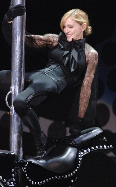 Madonna rides a stripper poll. 