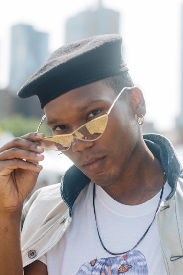 A man wearing a black beret and golden sunglasses at the Afropunk Festival 