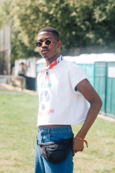 A man wearing a white t-shirt and black fanny pack at the Afropunk Festival 