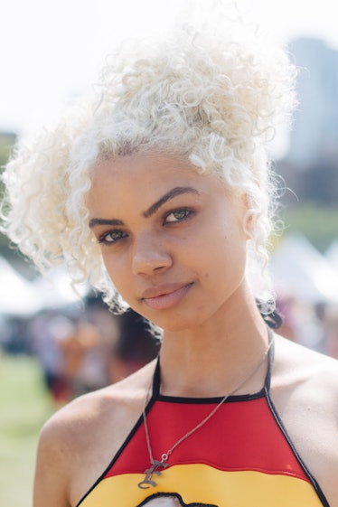A woman with a blonde afro in a ponytail at the Afropunk festival 