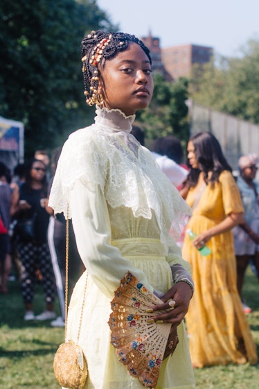 A woman in a white laced, long dress at Afropunk Festival