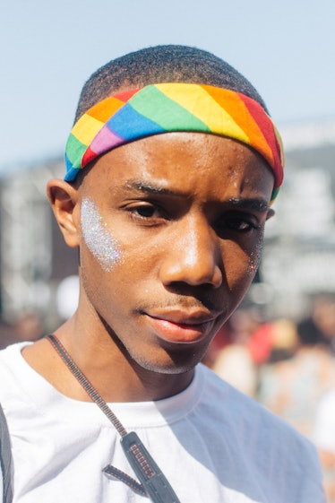 A man with a rainbow colored headband and white glittery face paint at Afropunk Festival 