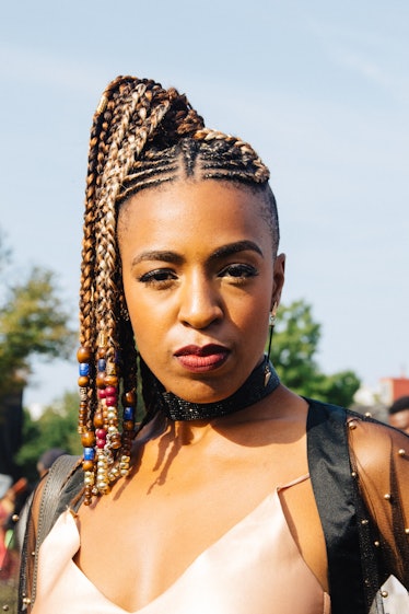 A woman with a dreadlock ponytail with beads in it at Afropunk Festival