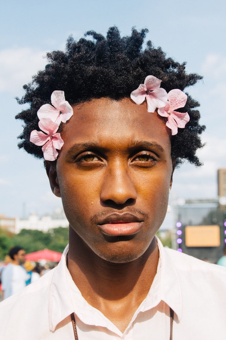 A man with pink flowers in his hair at Afropunk Festival