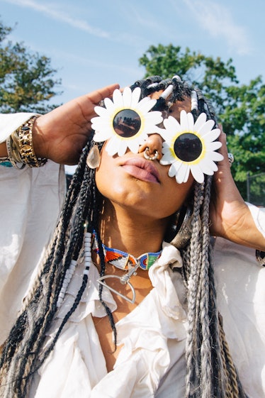 A woman wearing flower-shaped sunglasses and grey dreadlocks at Afropunk Festival 