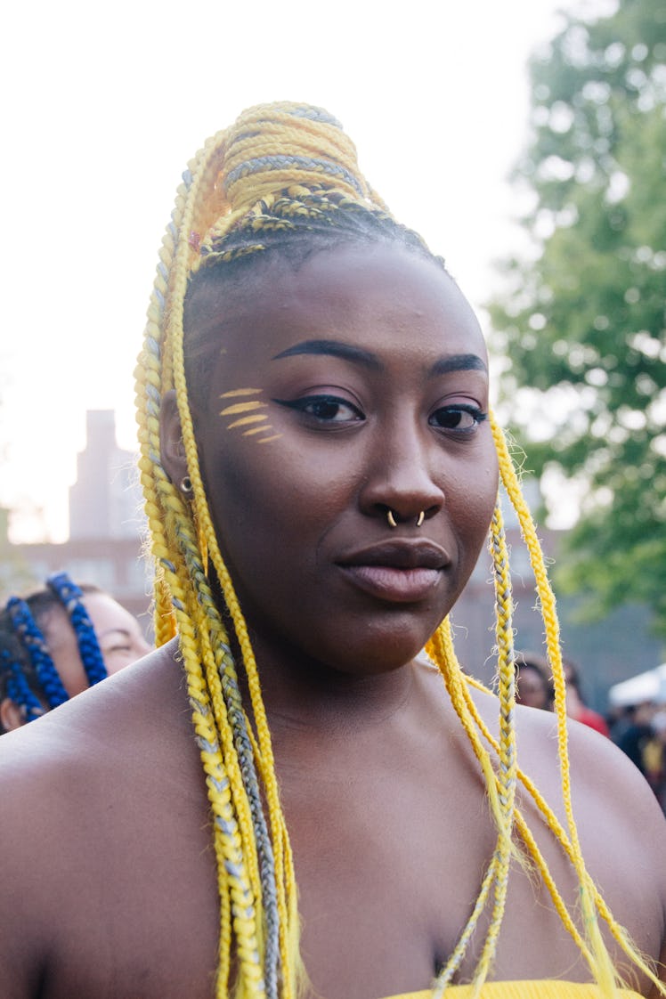 A woman with long yellow dreadlocks and a septum piercing at Afropunk Festival 