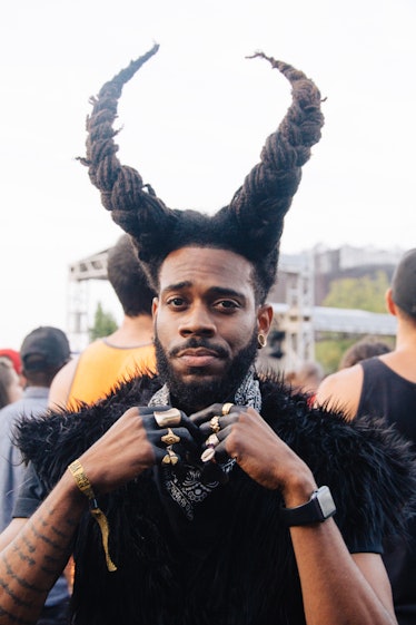 A main with his hair braided in the shape of horns at Afropunk Festival 