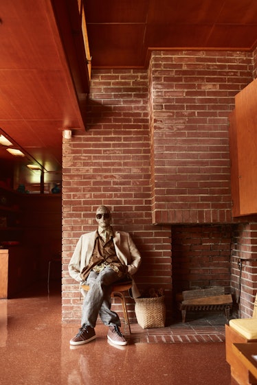 A mannequin in Billy Reid's spring 2018 collection look next to the fireplace in Frank Lloyd Wright’...