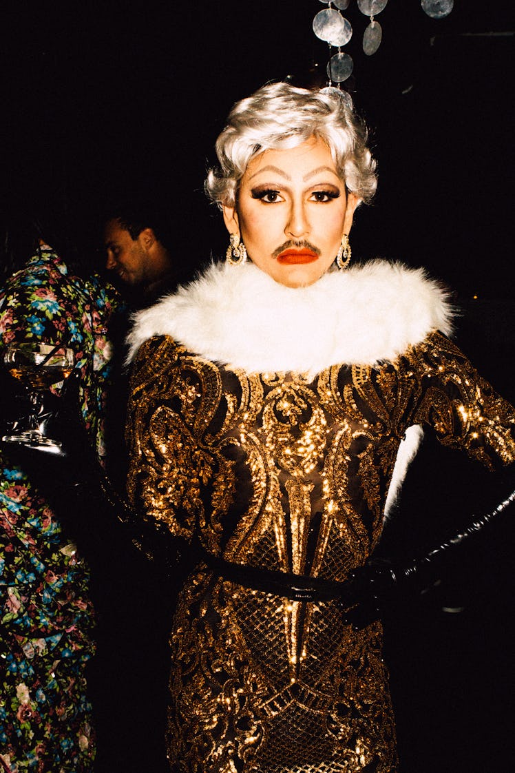 An attendee in a gold-black dress with white fur collar at Marc Jacobs and RuPaul’s Drag Ball at New...