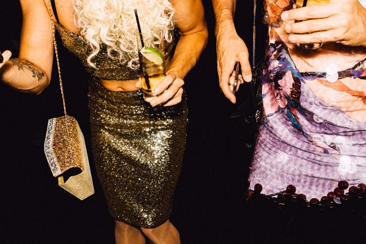 A guest in a gold sequin top and skirt and a guest in a pink sequin dress  at Marc Jacobs and RuPaul...