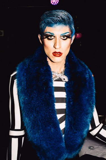 An attendee in a black-white striped top and blue fur scarf at Marc Jacobs and RuPaul’s Drag Ball