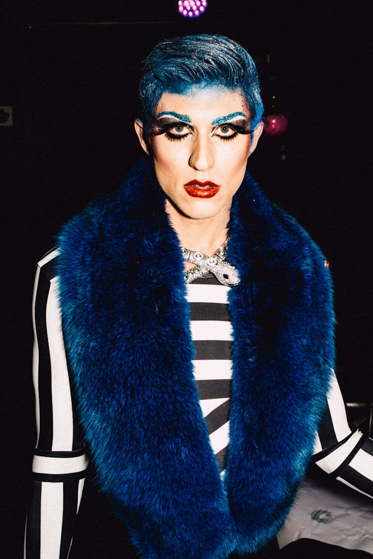An attendee in a black-white striped top and blue fur scarf at Marc Jacobs and RuPaul’s Drag Ball
