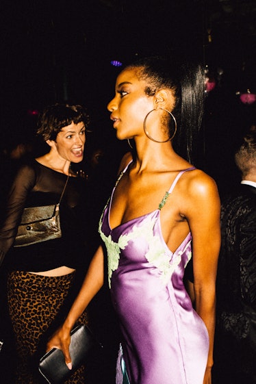 A woman in a lilac satin dress and large hoop earrings at Marc Jacobs and RuPaul’s Drag Ball