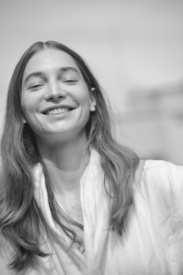 A black and white photo of a model smiling at the Maryam Nassir Zadeh Spring/Summer 2018 show 