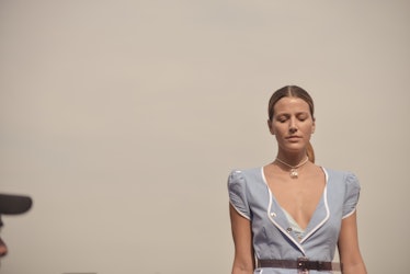 A model in a light blue dress and her hair in a low ponytail walking the Maryam Nassir Zadeh runway,...