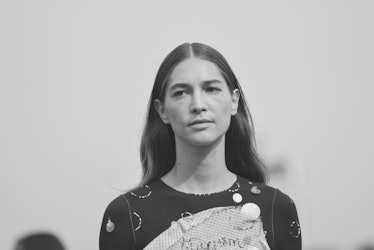 A closeup in black and white of a model walking the runway at the Maryam Nassir Zadeh Spring/Summer ...