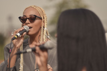Solange with blonde hair and sunglasses angled upwards, singing at the Maryam Nassir Zadeh Spring/Su...