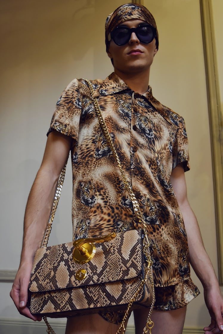 A model wearing a tiger print shirt and short and a brown bag at the Palomo Spain SS18 runway