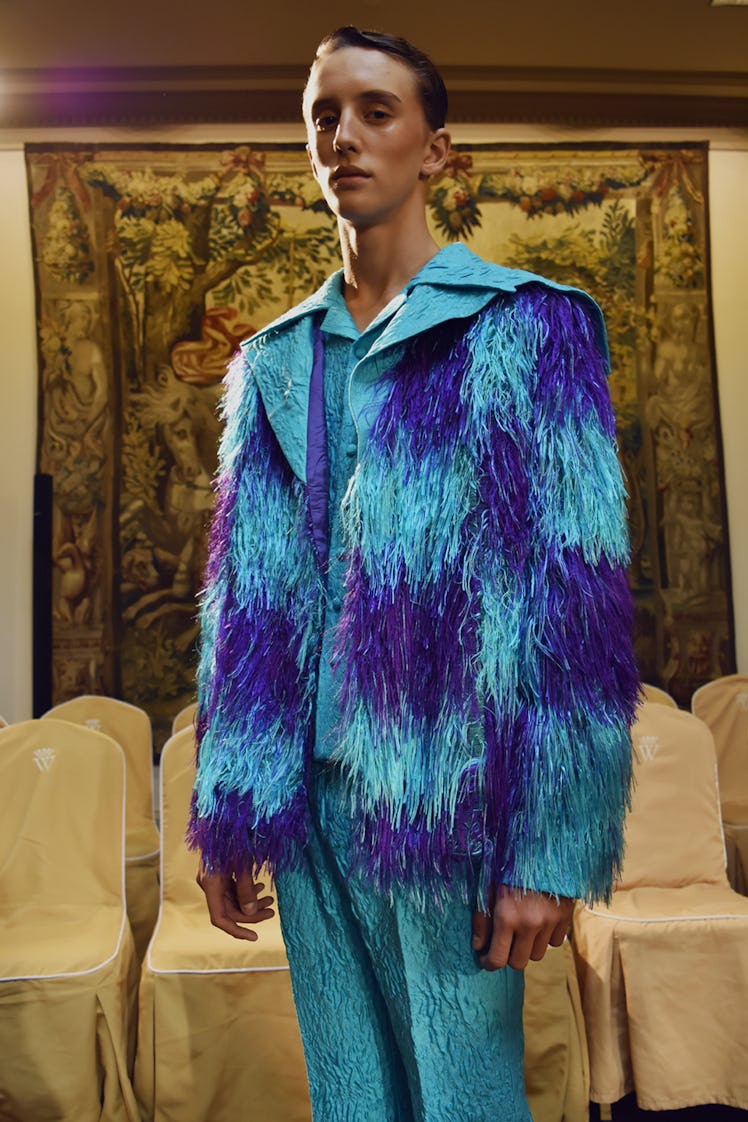 A model in a blue feather jacket and satin trousers at the Palomo Spain SS18 runway