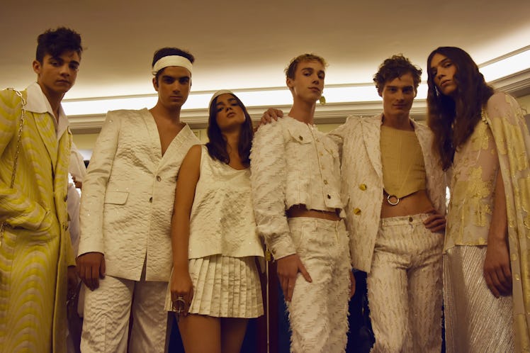 Six models wearing white and yellow outfits backstage at the Palomo Spain SS18 runway