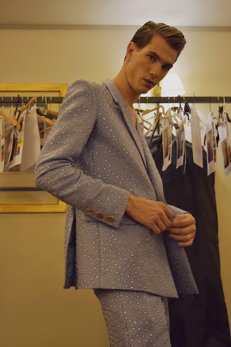 A model in a blue-white dotted suit backstage at the Palomo Spain SS18 runway