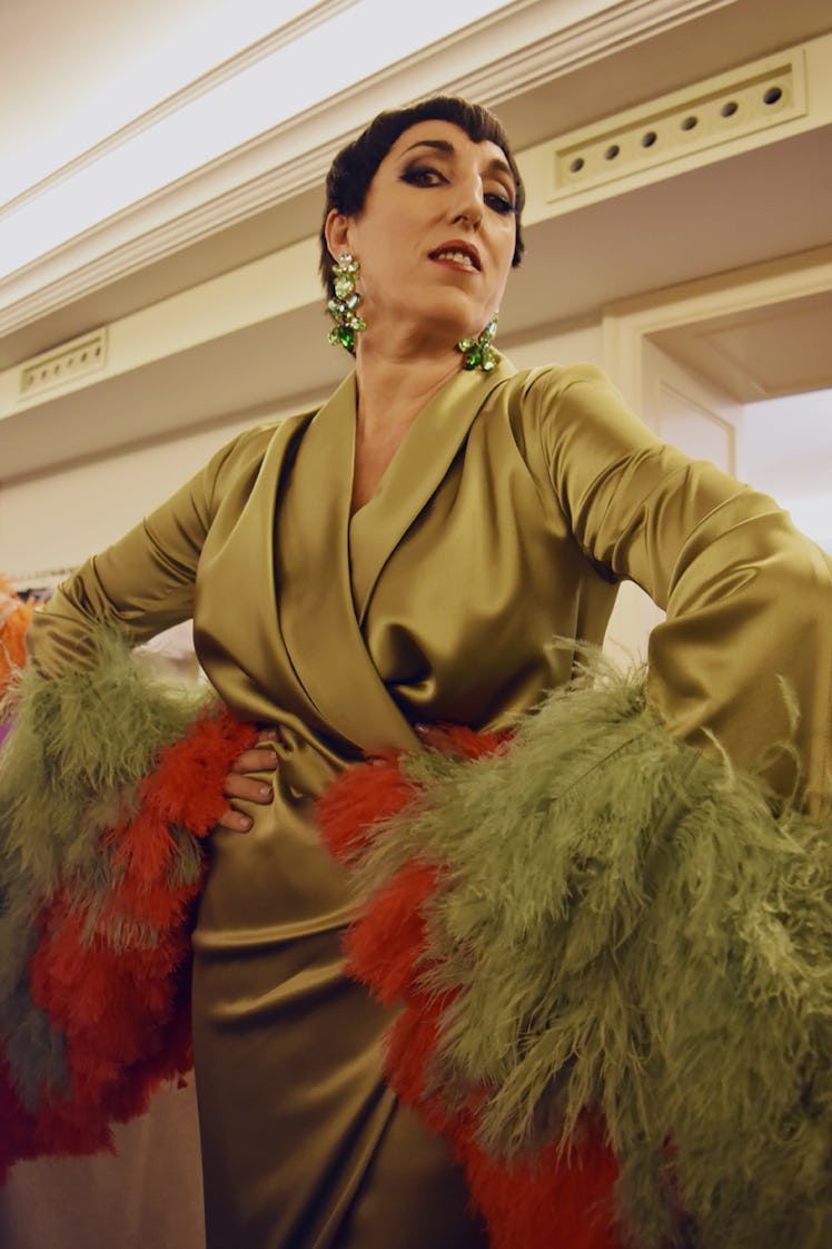 A woman in a green satin dress with feathers at the Palomo Spain SS18 runway