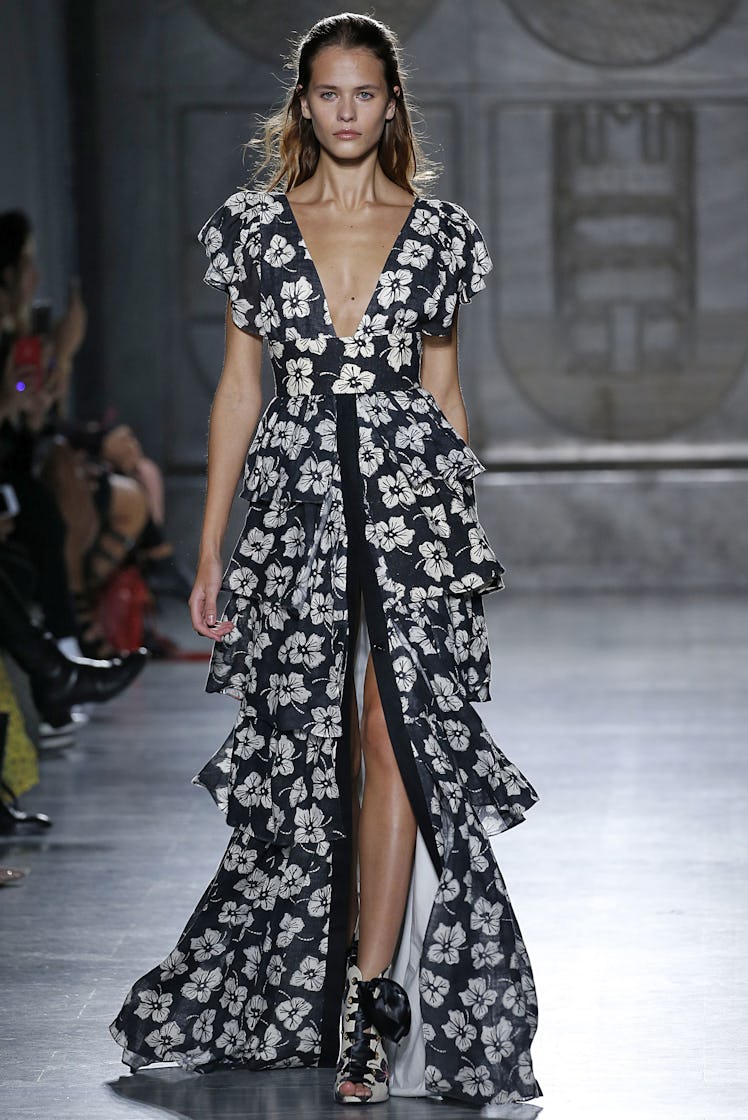A model walking the runway in a floral pattern dress for Fausto Puglisi’s show during Milan Fashion ...