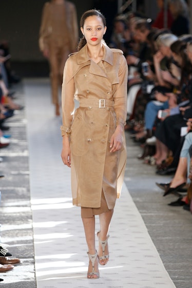 A model walking the runway in a beige trench coat for Max Mara’s show during Milan Fashion Week’s Sp...