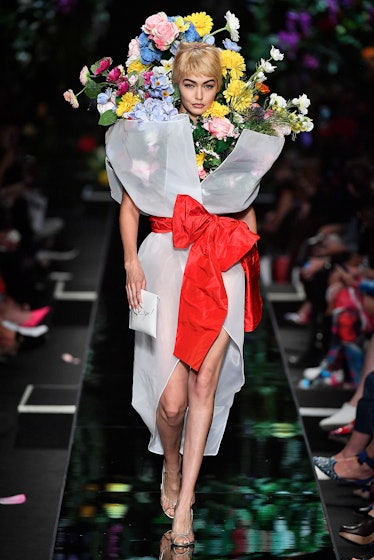 Gigi Hadid transformed into a giant size bouquet walking the runway for Moschino’s show during Milan...