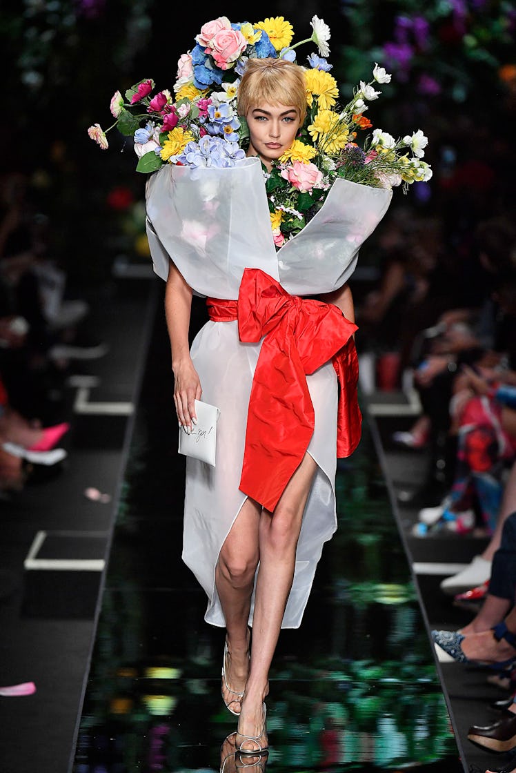 Gigi Hadid transformed into a giant size bouquet walking the runway for Moschino’s show during Milan...