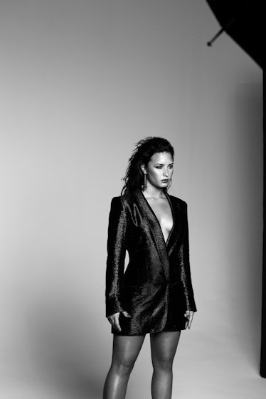 Demi wearing a black mini dress on her "Tell Me You Love Me" album cover shoot in black and white