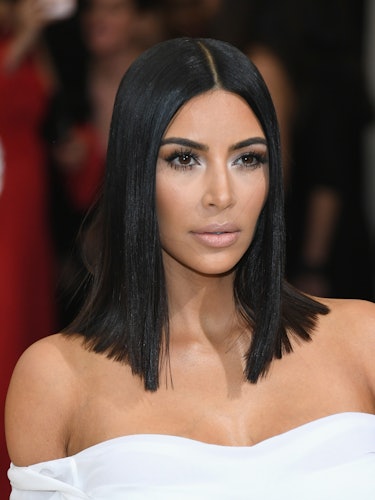 Kim Kardashian at the Met Gala in a white strapless dress, sporting a shoulder-grazing bob 