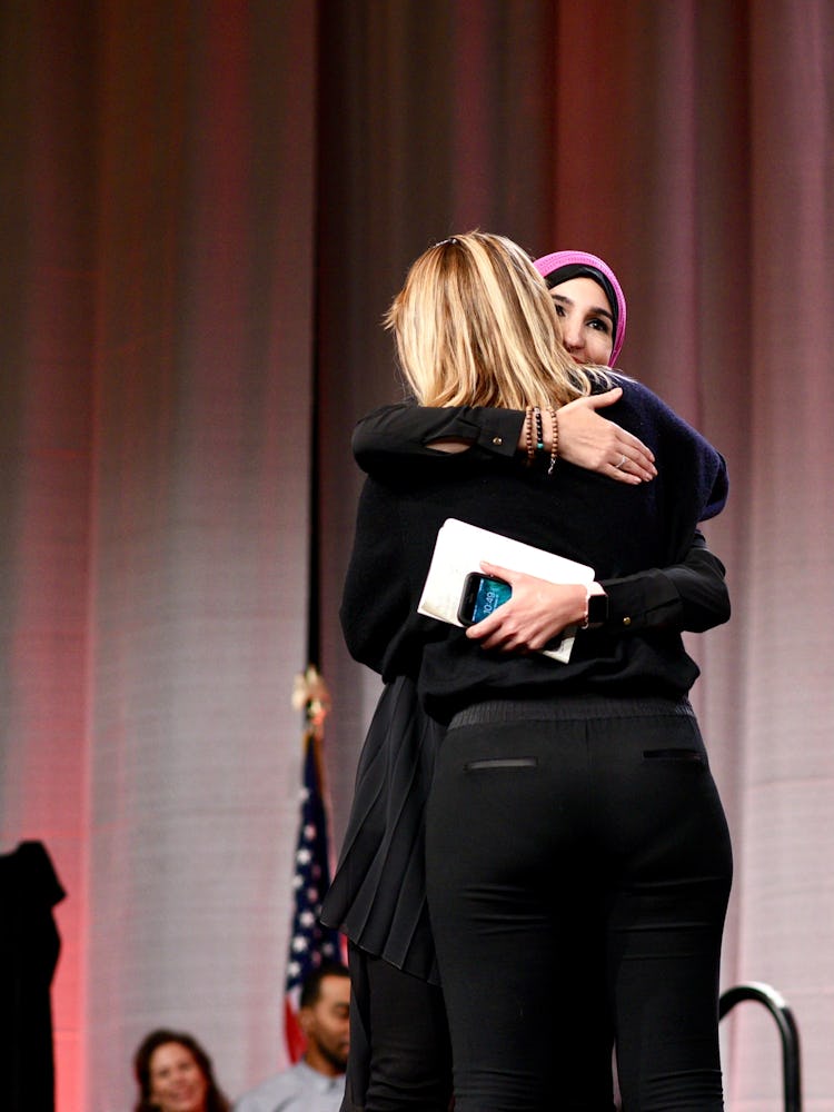 Linda Sarsour hugging another activist on stage