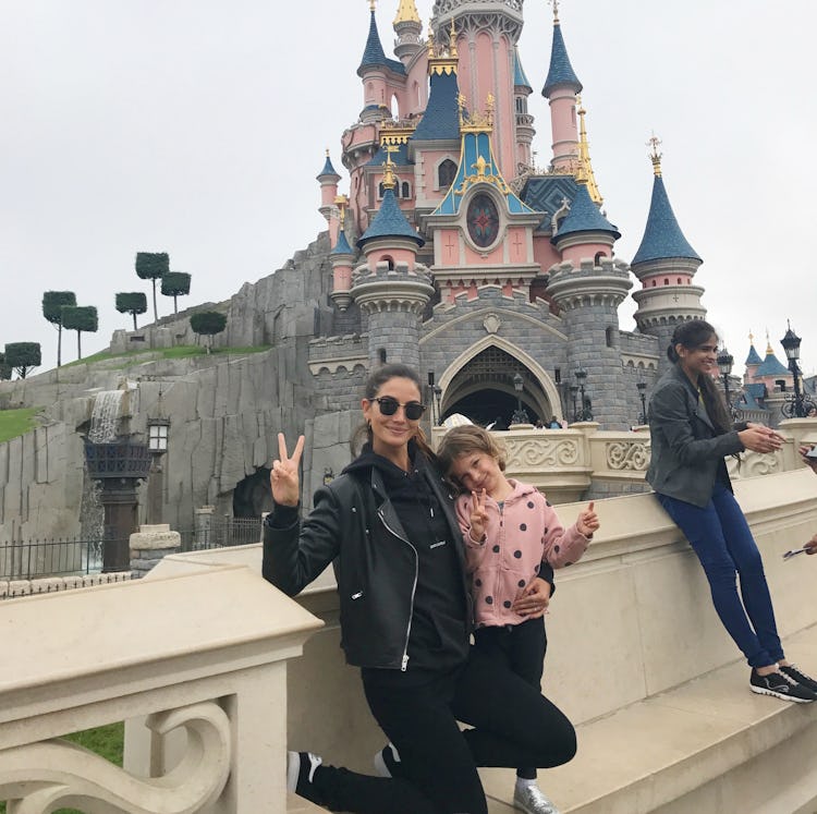 Lily Aldridge posing with her daughter in Disneyland 