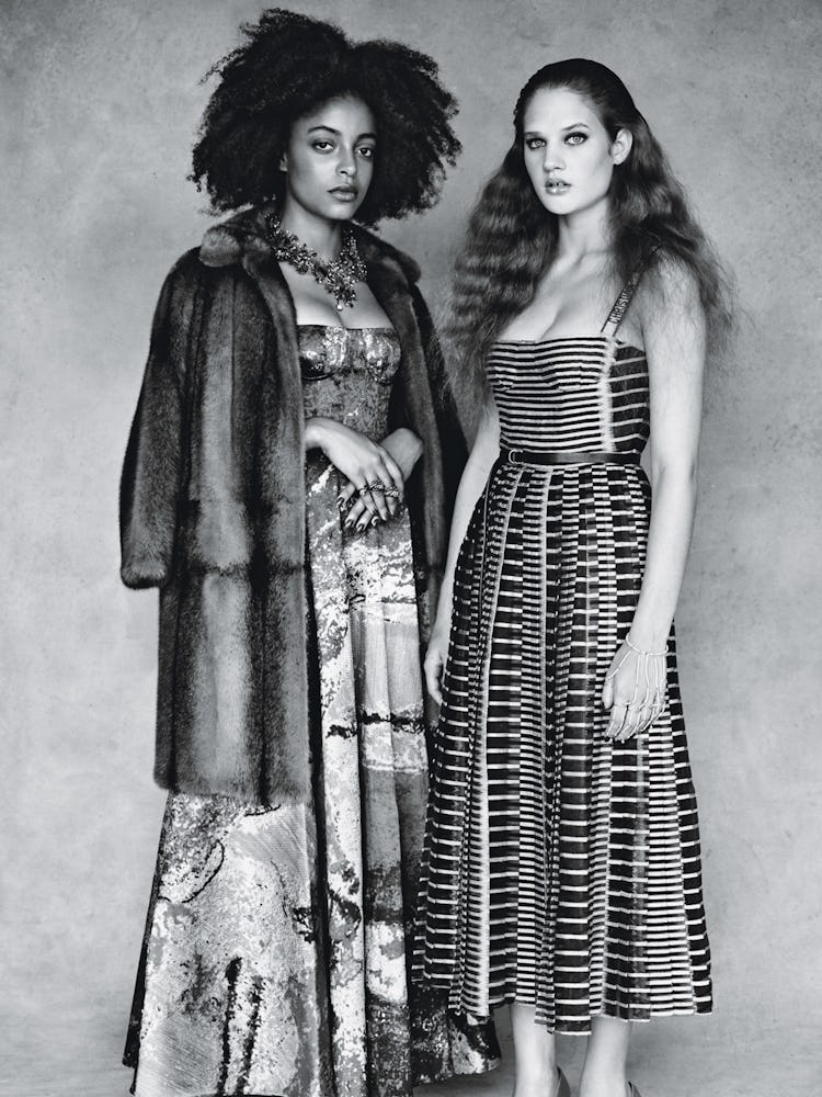 Two models in Dior Belted dresses standing and posing in black and white