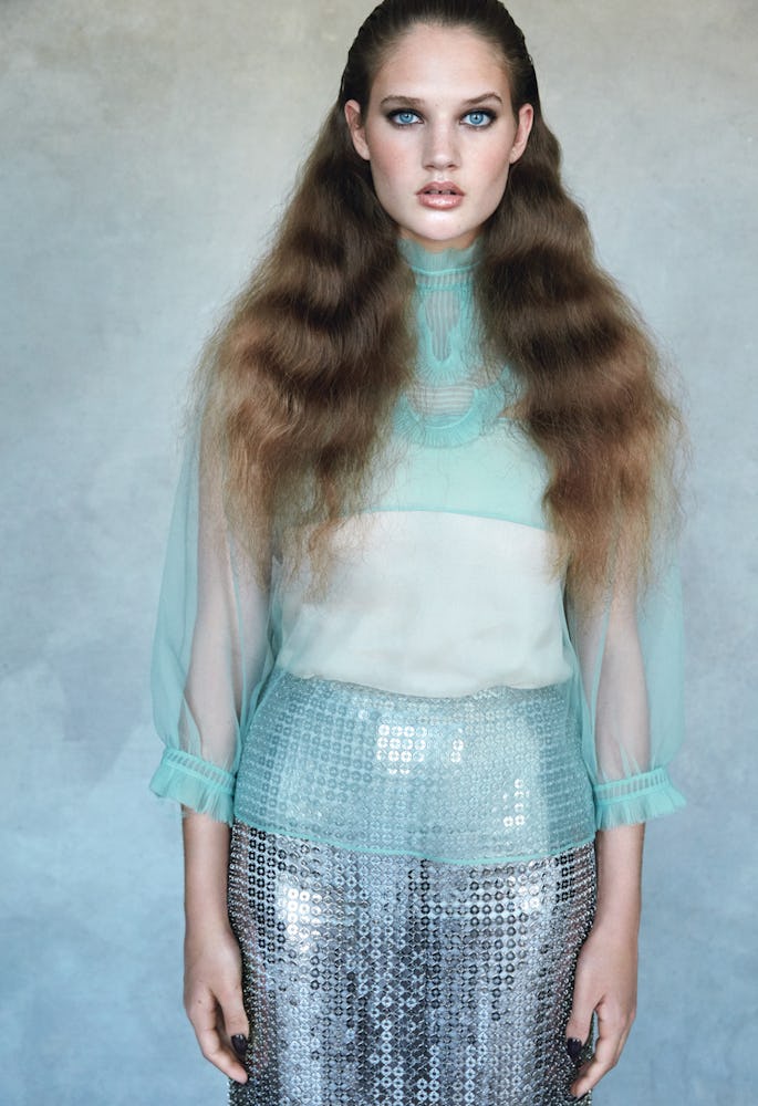 A model in a blue tulle Prada top and tank and a silver sequin skirt