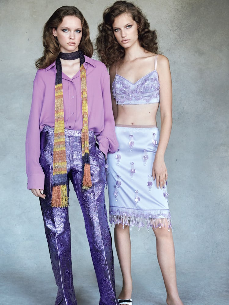 A model in a purple Hermes shirt and purple Gucci pants; a model in a lilac Marc Jacobs top and skir...